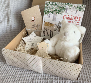 Baby's first Christmas gift box which includes a christmas decoration, bear soft toy, bear push along wooden toy, christmas is love book and a christmas card