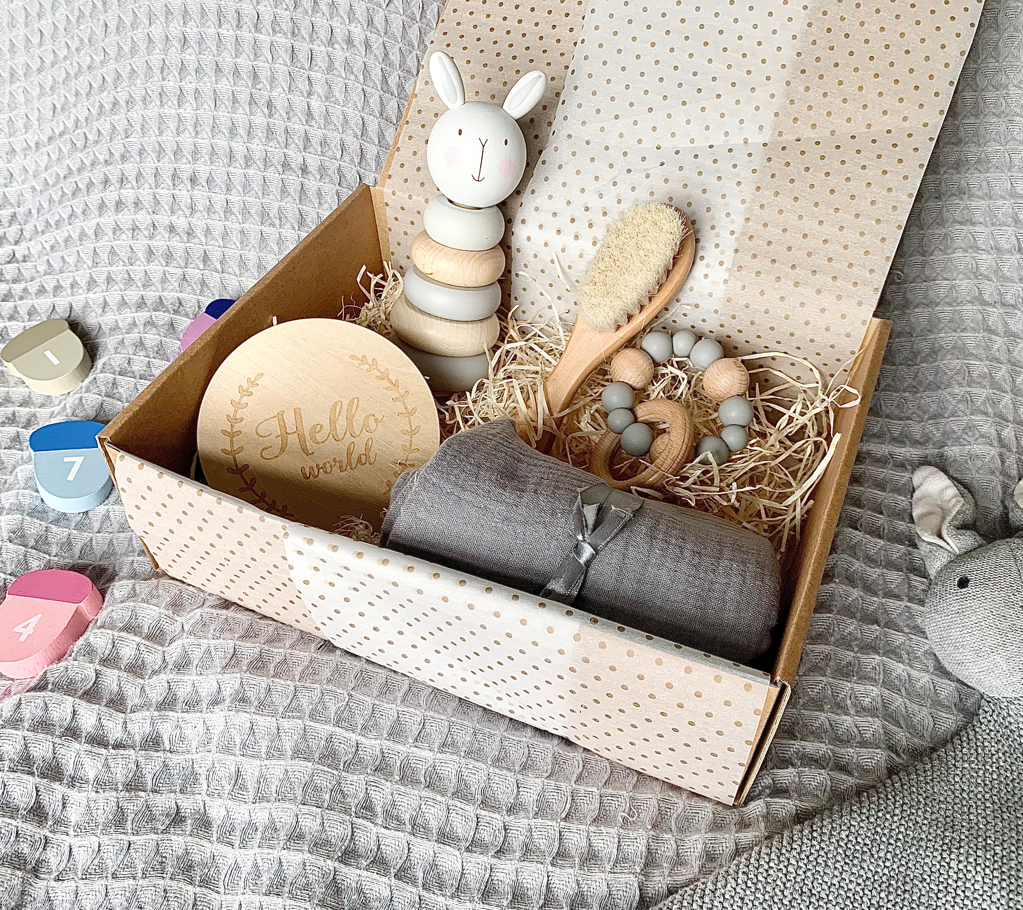 Classic gift box with wooden stacking toy, announcement disc, brush, teether and muslin