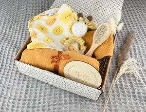 Ray of Sunshine Baby Gift Set containing Angel Dear sunshine baby grow, yellow giraffe crochet rattle, wooden soft bristle brush, 100% cotton mustard bib and muslin and Hello World wooden announcement disc