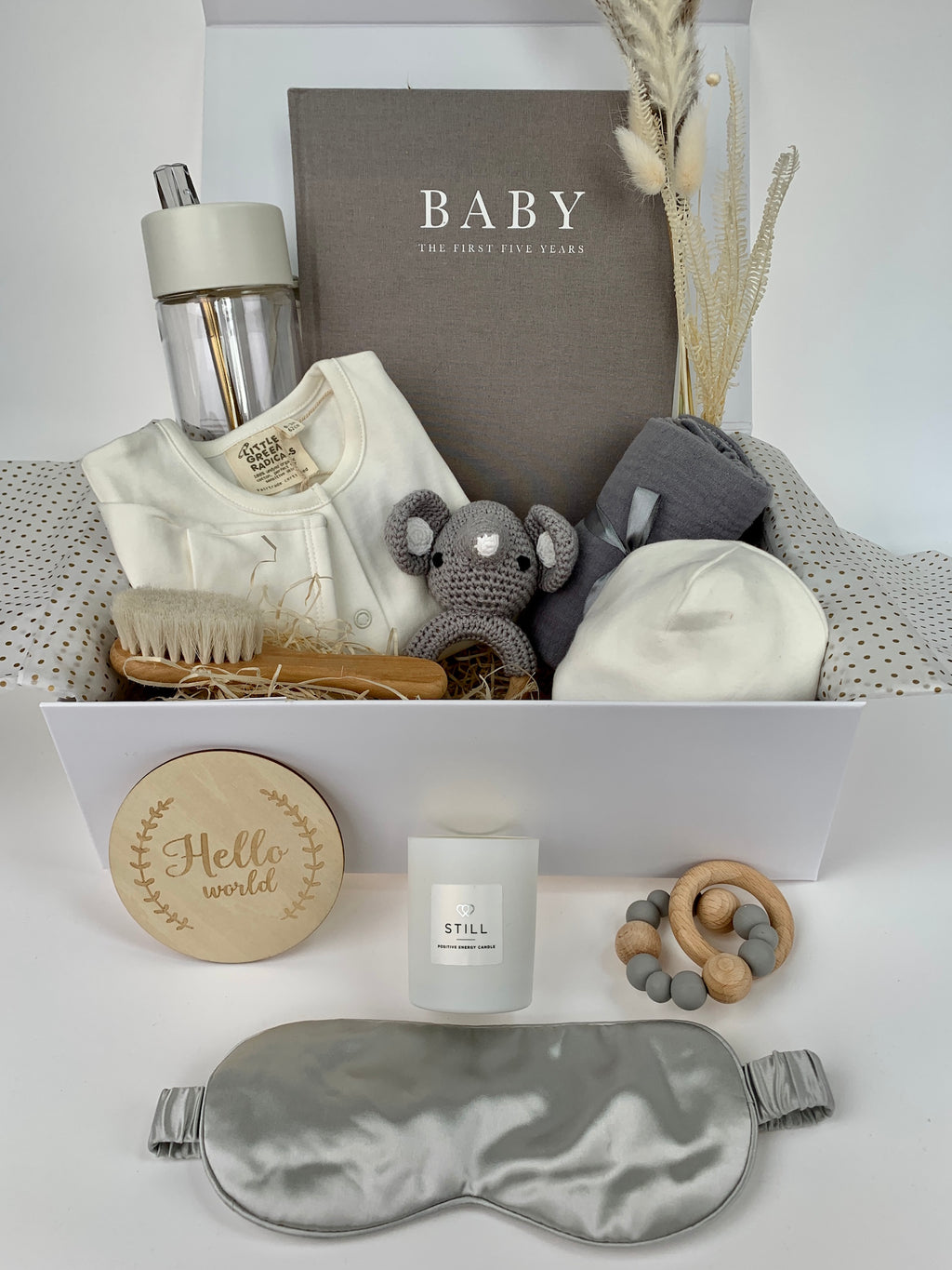 Ultimate mama baby gift set containing Baby record journal book in grey, white long sleeve baby grow and hat by Little Green Radicals, grey elephant crochet rattle, 100% cotton grey muslin, wooden soft bristle brush, Hello World wooden announcement disc, wood and silicon grey teether, 100% silk eye mask and Frank Green water bottle