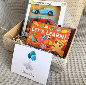 Third birthday gift box with retro wooden cars, lets learn books and three today birthday card