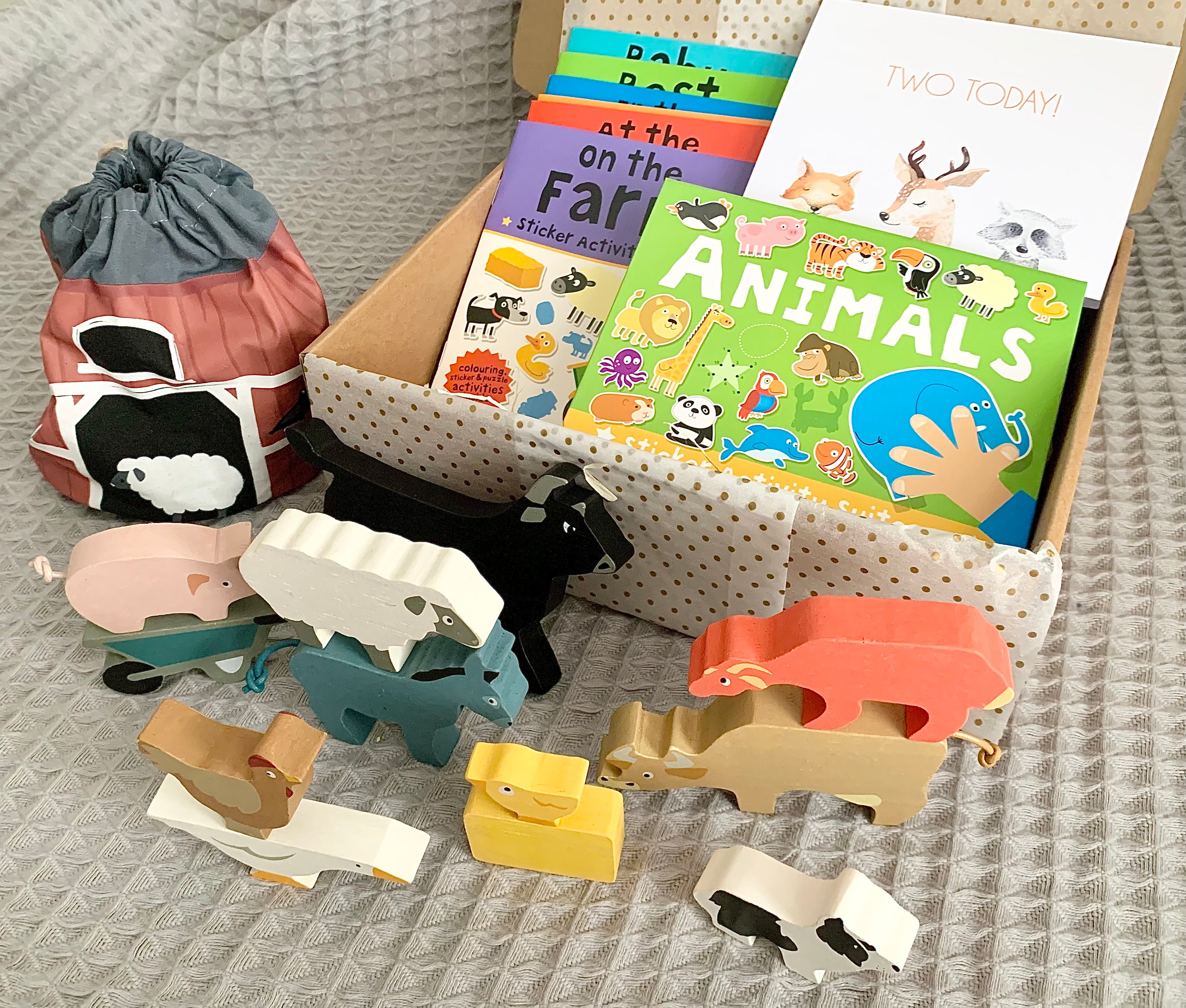 Second birthday box with wooden farm animals, animals sticker activity suitcase and two today card